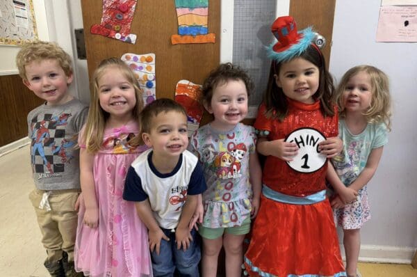 Group of smiling preschoolers in colorful costumes